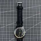 Taihang 32mm manual mechanical watch featuring black strap, gold markers, and black dial for classic style.