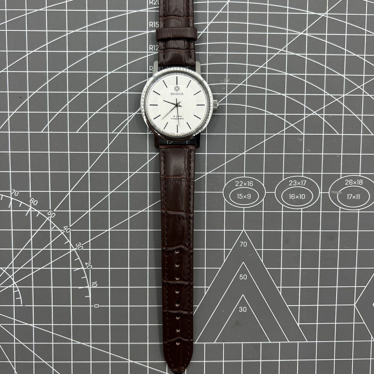 China Baihua 37mm manual mechanical watch with silver dial, 19 jewels, shock-resistant for durable everyday wear.