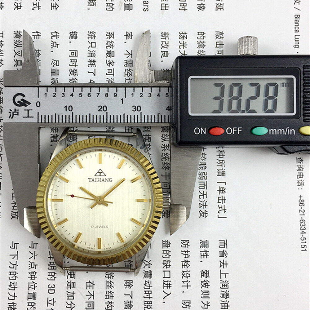 TAIHANG 38mm manual mechanical watch with silver dial, golden nail markers, round case, and 17 jewels.
