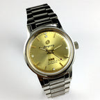 Donglang Steel automatic watch with 17 jewels, golden dial, and stainless steel band for elegant wear.