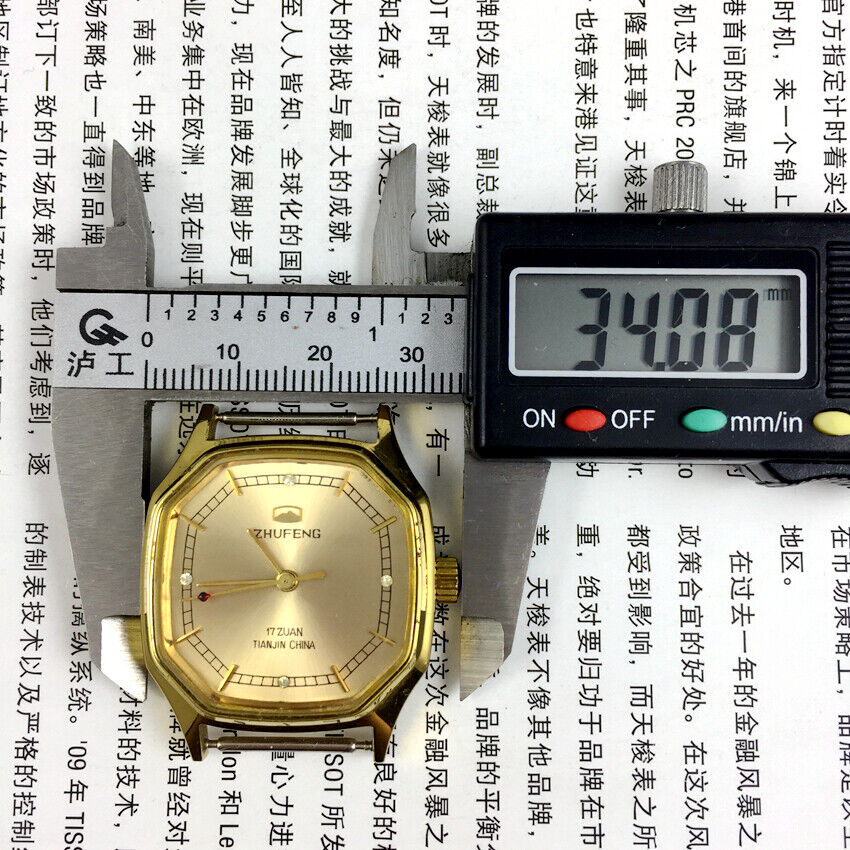 Golden octagonal 34mm Zhufeng Tianjin manual mechanical watch with intricate nail design.