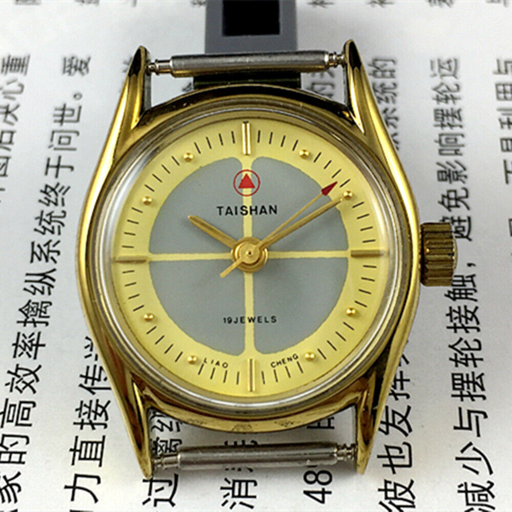 TAISHAN manual mechanical lady watch with 19 jewels, yellow-grey dial, and round golden case for elegant style.