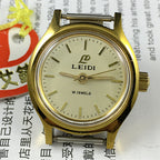 27mm Leidi Steel Lady Watch with golden dial and 18 jewels, paired with matching watch band for elegant style.