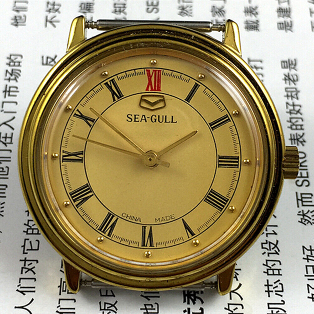 35mm Tianjin Seagull watch with golden round case and dial, manual mechanical movement, elegant design