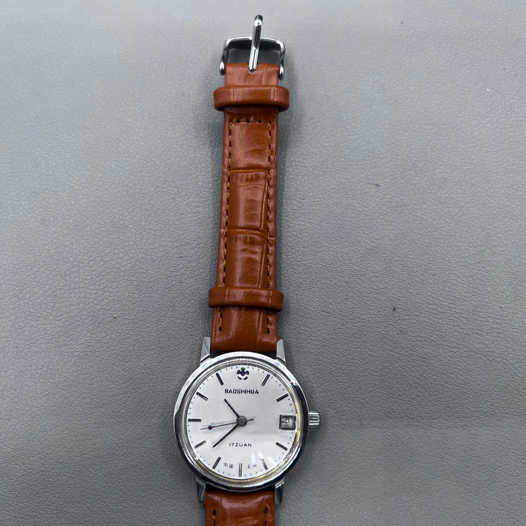 Light brown Shanghai manual mechanical watch with single calendar, 17 jewels, shock-resistant design for durability.
