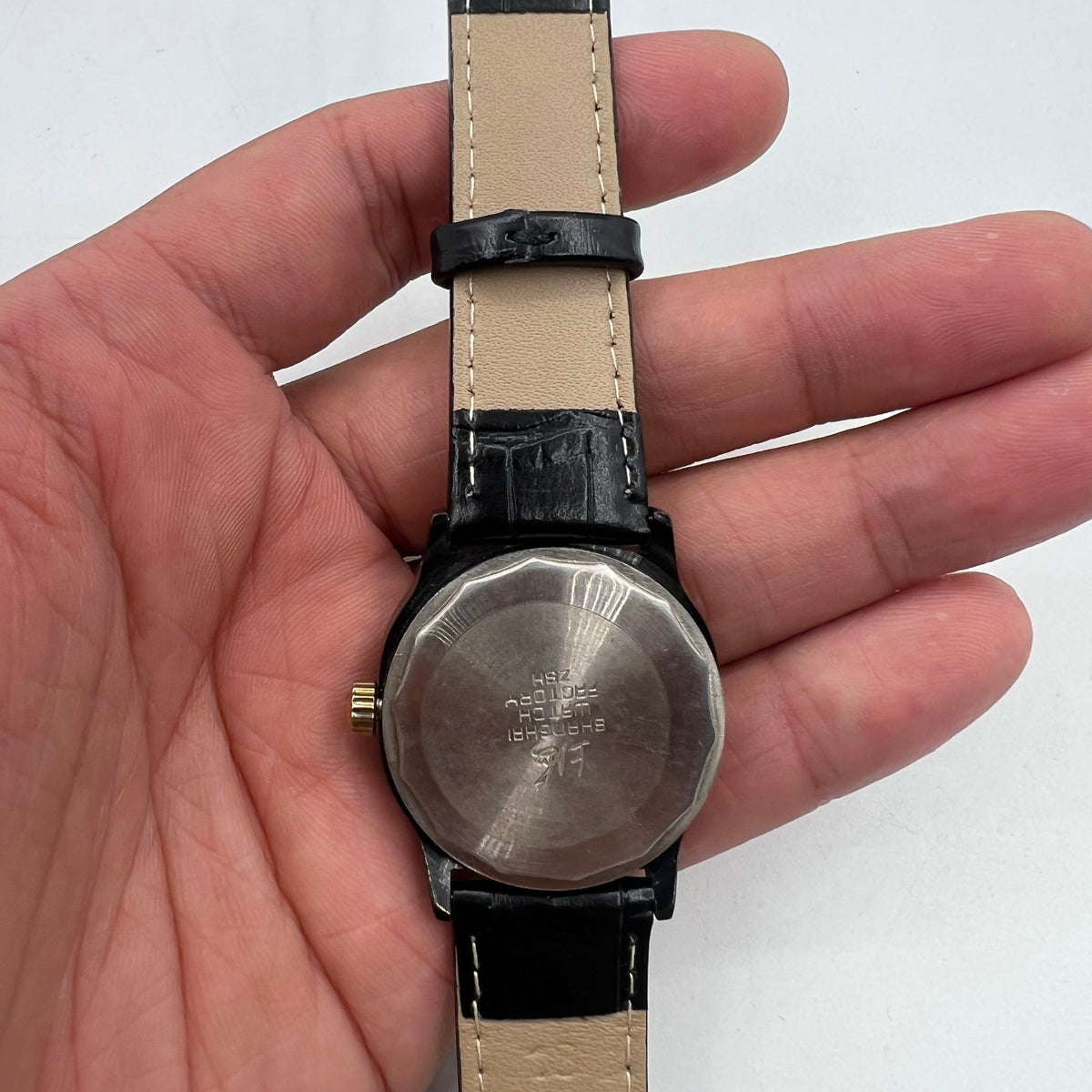 34mm Shanghai Factory manual watch with black dial, 19 jewels, shock-resistant for durability and precision.