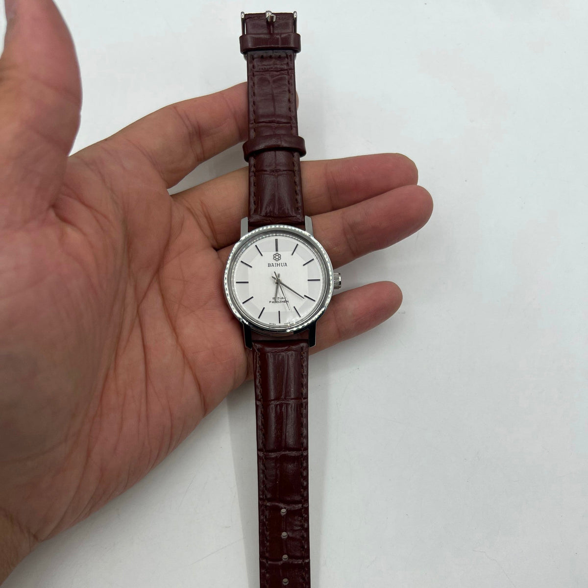 37mm China Baihua manual mechanical watch with silver dial, 19 jewels, shock-resistant design.