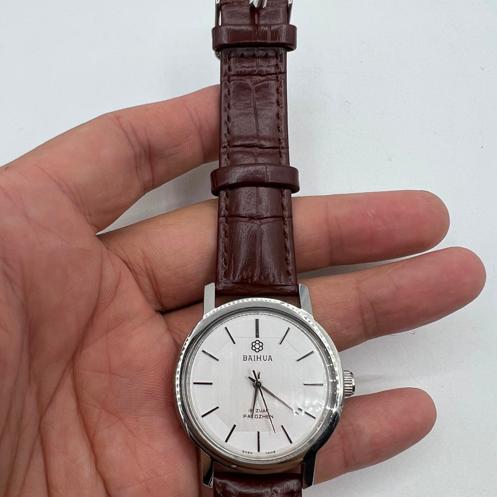 37mm China Baihua manual mechanical watch with silver dial, 19 jewels, shock-resistant design.