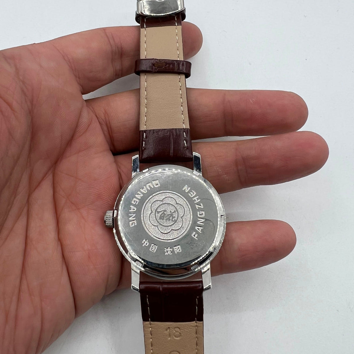 China Baihua 37mm manual watch with silver dial, 19-jewel shock-resistant mechanical movement.