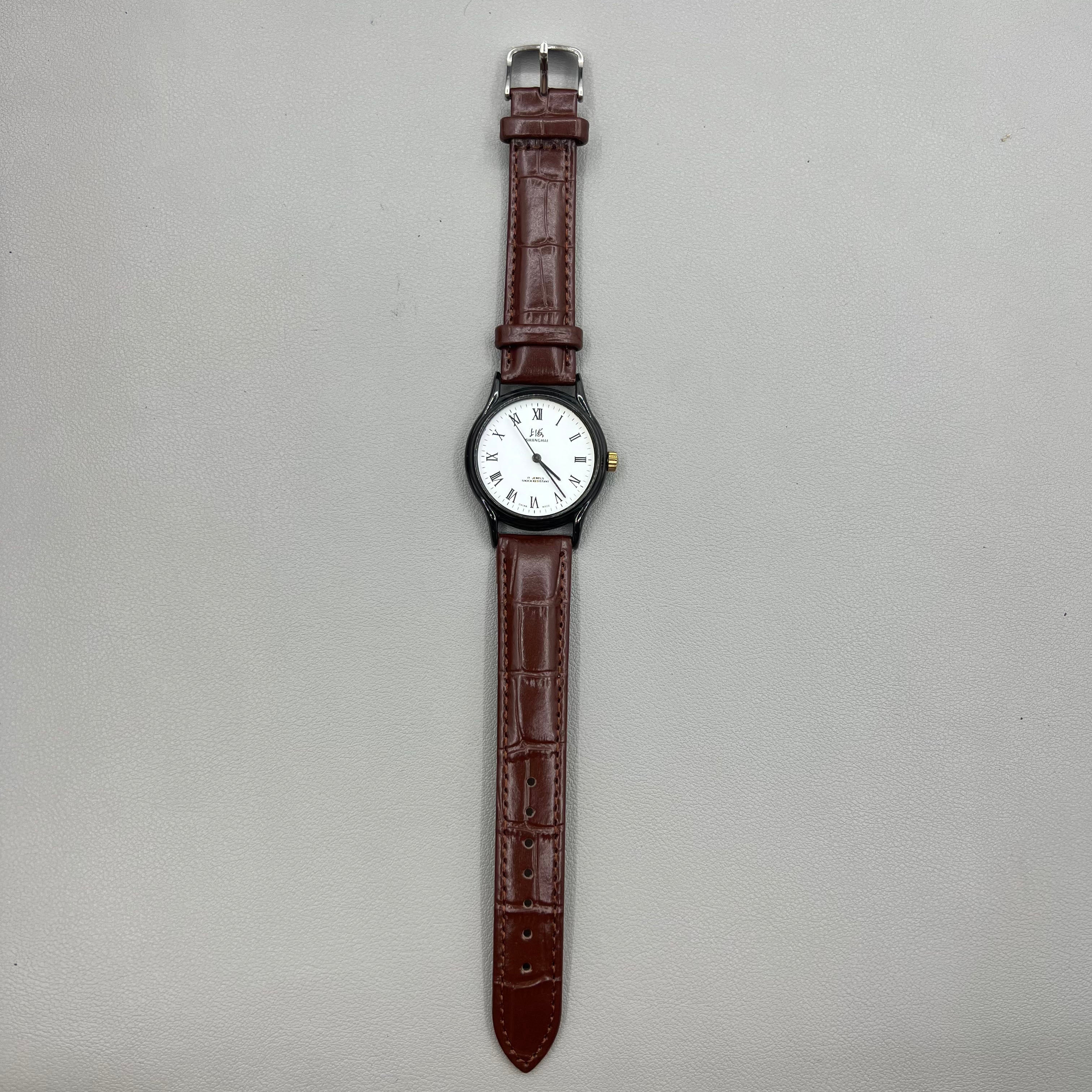 Shanghai 37mm manual mechanical watch with brown leather strap, Roman numerals, 17 jewels, classic style.