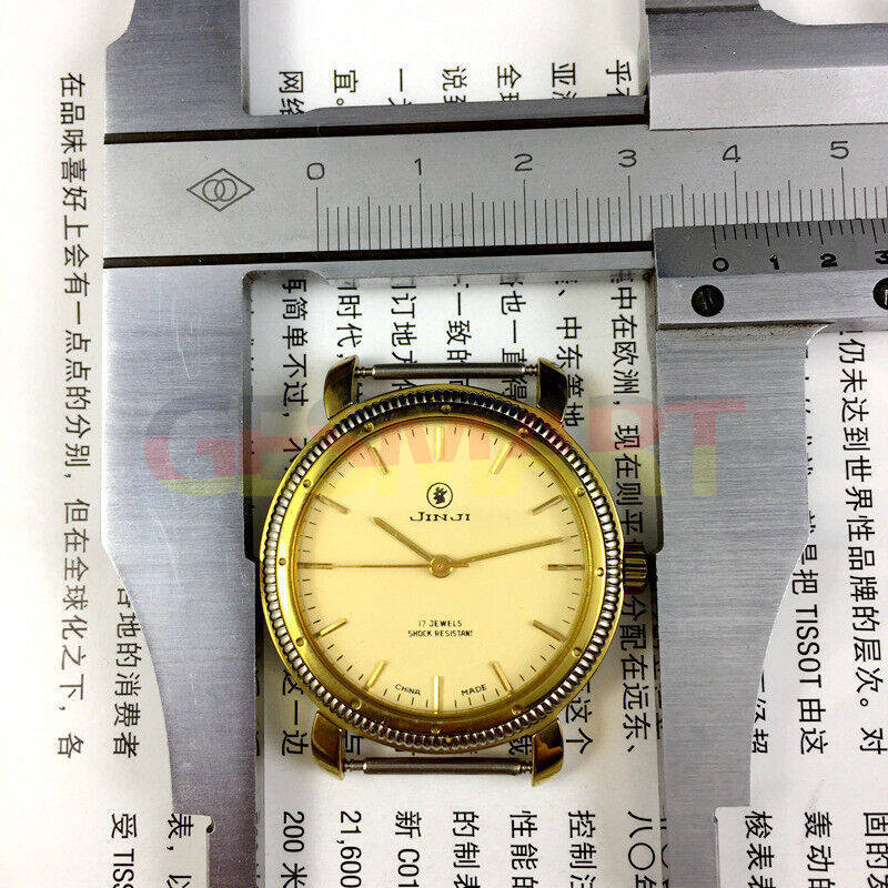 Shanghai Jinji 37mm manual watch with 17 jewels, shock-resistant, gold-tone nail accents and classic design.