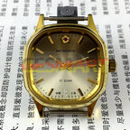 Shanghai Manual Mechanical Watch with golden indices, light brown dial, and elegant octagonal stainless steel case by Shanghai.