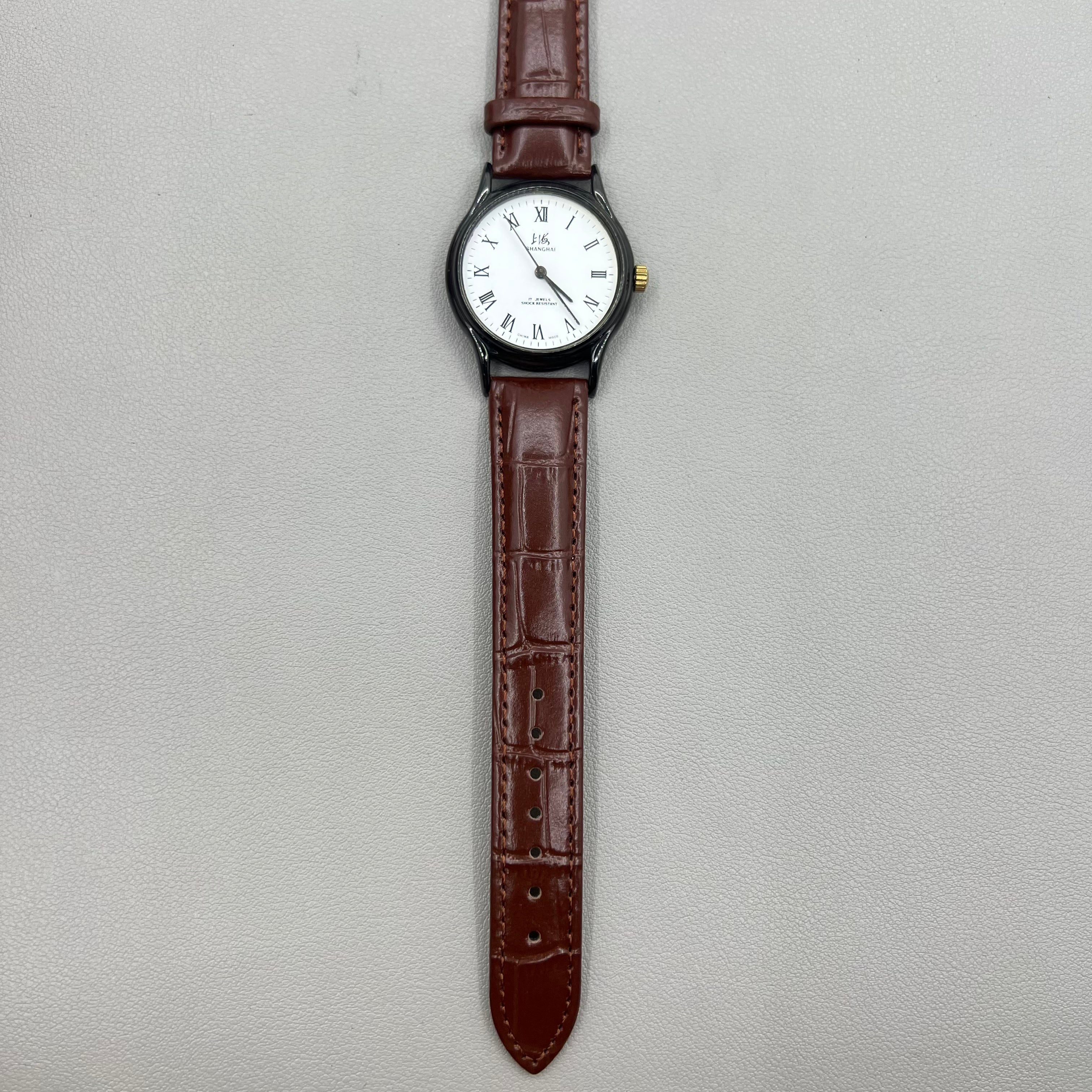 Shanghai 37mm manual mechanical watch with brown leather strap, Roman numerals, 17 jewels, classic style.