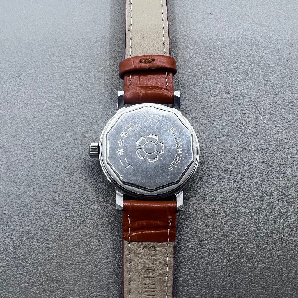 Light brown Shanghai manual mechanical watch with single calendar, 17 jewels, shock-resistant design for durability.