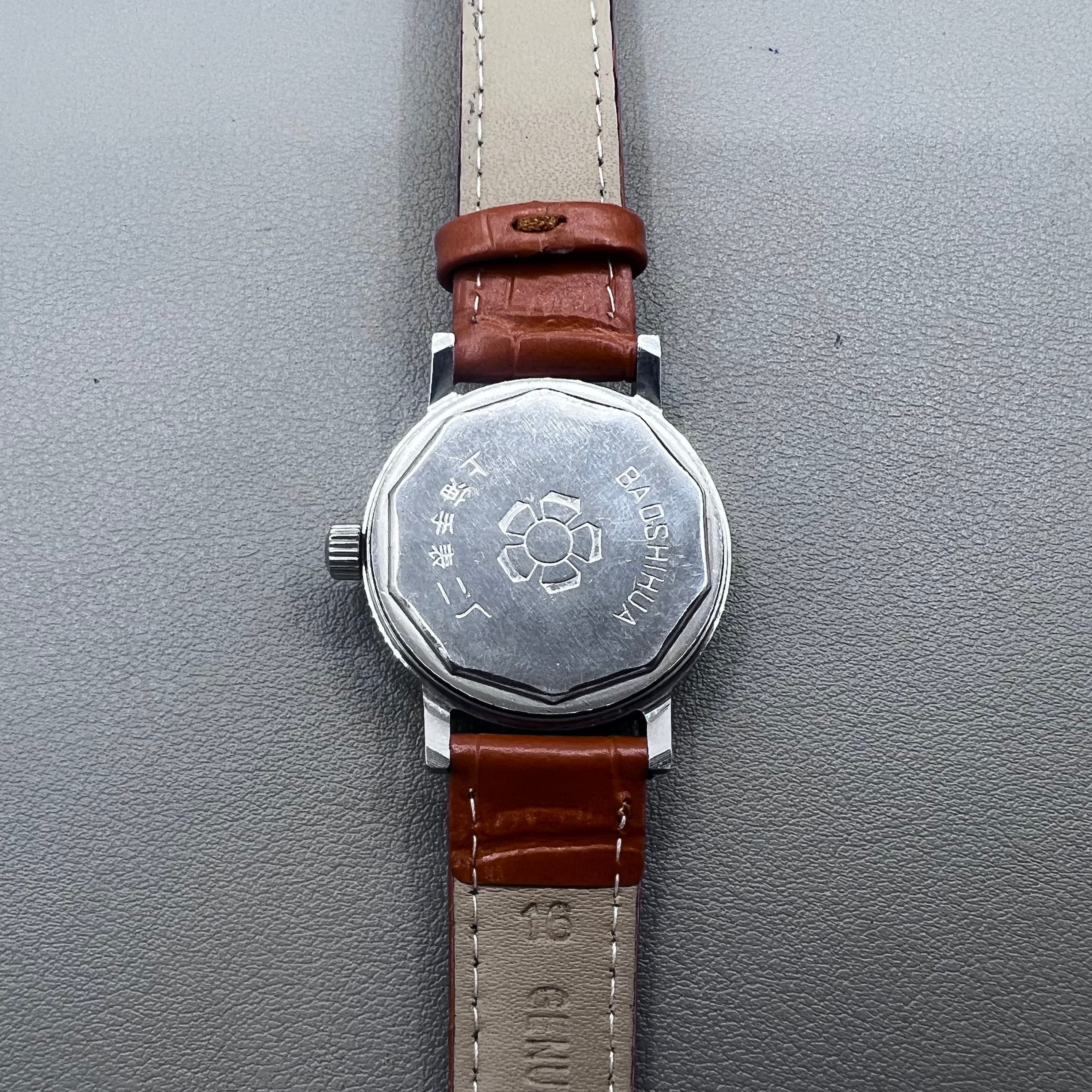 Light brown Shanghai manual mechanical watch with single calendar, 17 jewels, shock-resistant design for durability.