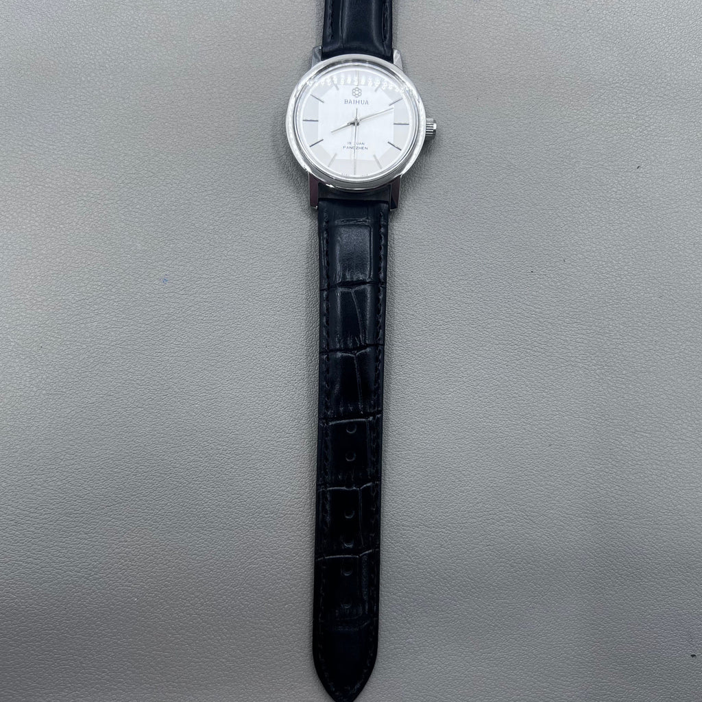 37mm China manual mechanical watch with black strap, silver dial, 19 jewels, shock-resistant design.