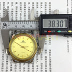 38mm TAIHANG manual mechanical watch with golden dial, nail markers, round case, and 17 jewels.