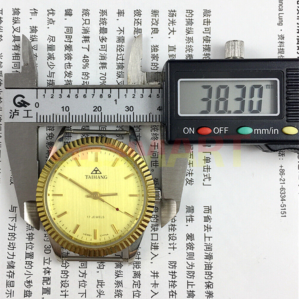 38mm TAIHANG manual mechanical watch with golden dial, nail markers, round case, and 17 jewels.