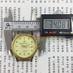32mm manual mechanical watch featuring yellow dial and green lume hands with 17 jewels.