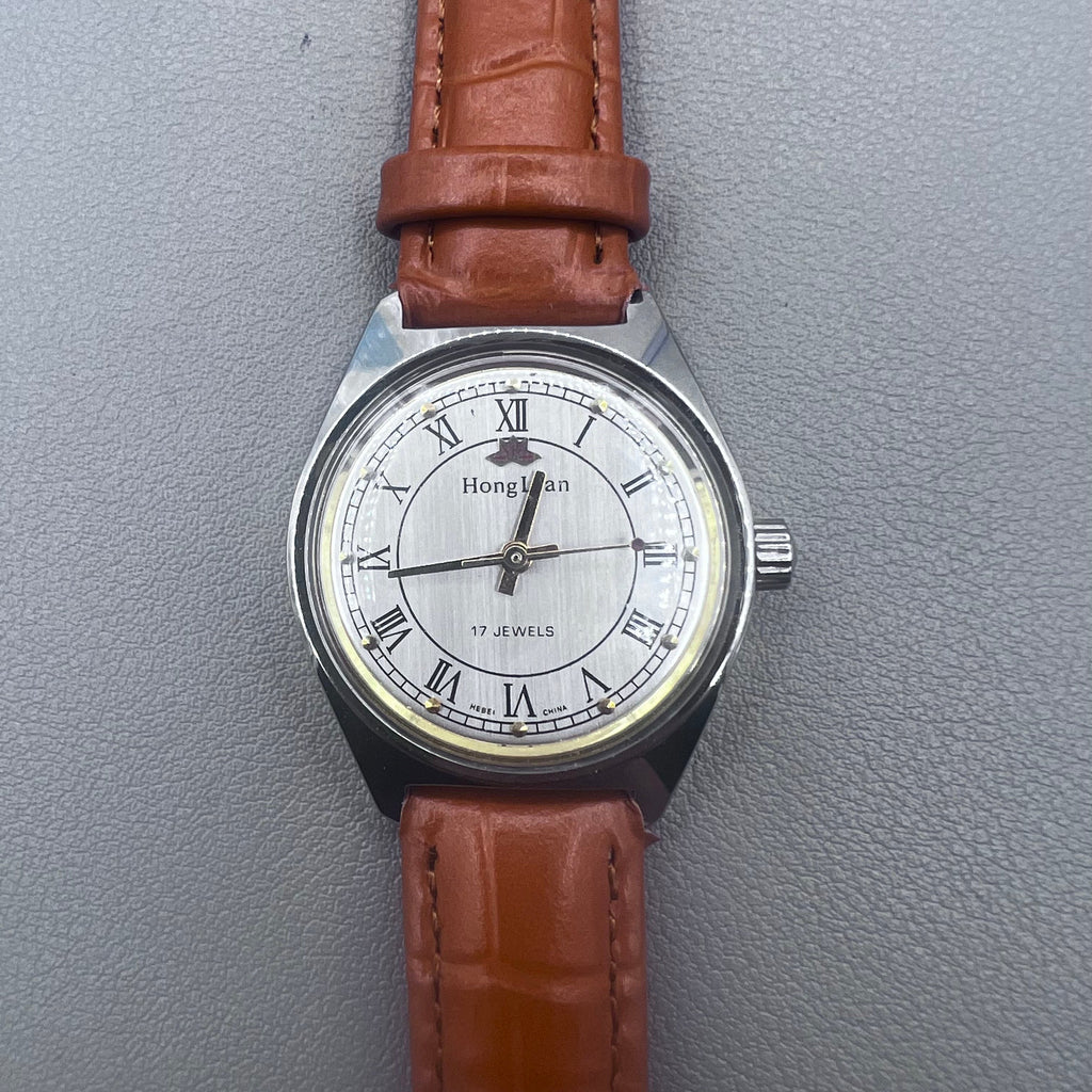 HONGLIAN 32mm brown leather band manual watch with 17 jewels and Roman numeral dial.