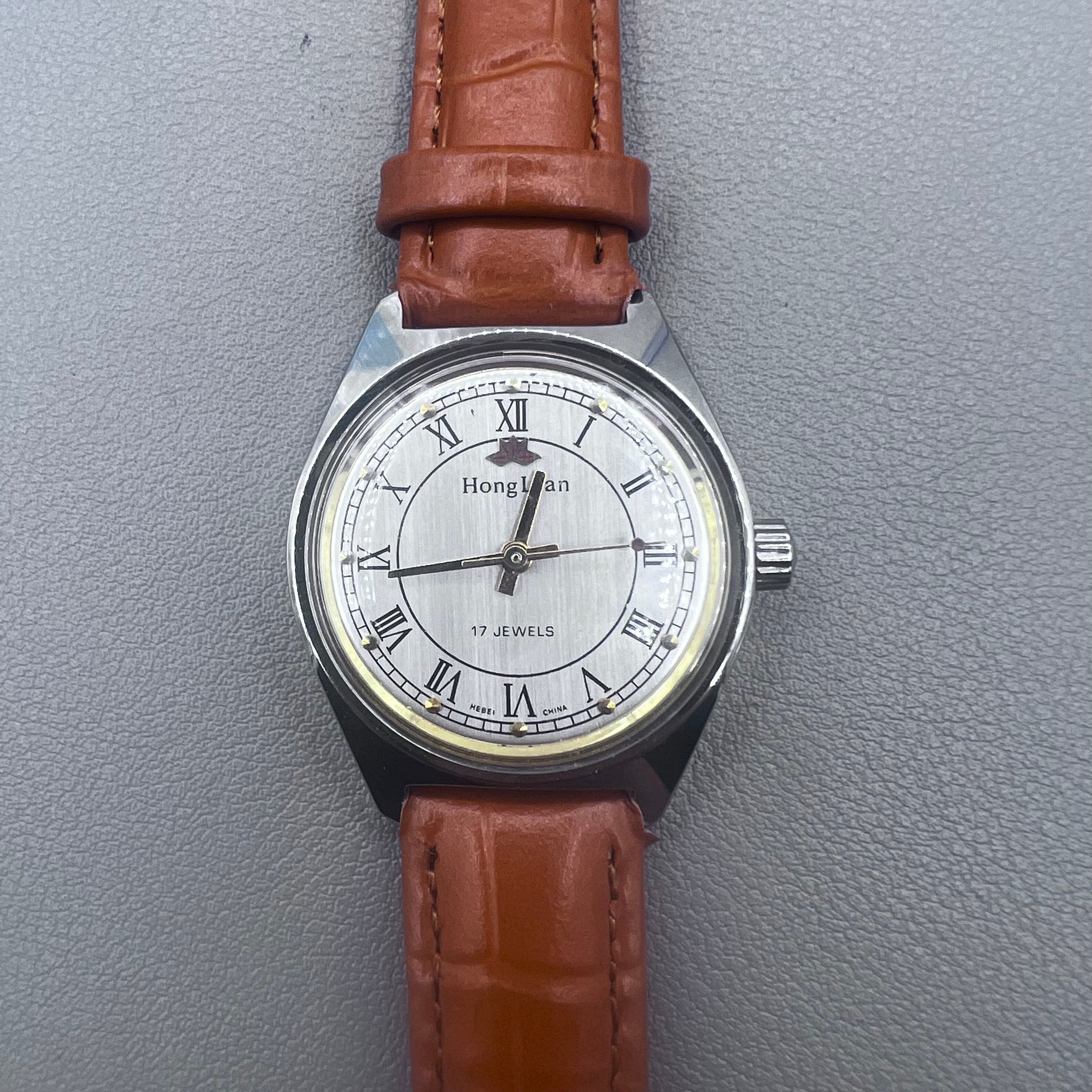 HONGLIAN 32mm brown leather band manual watch with 17 jewels and Roman numeral dial.