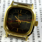 HONGLIAN 34mm manual mechanical watch with black dial, golden nail markers, and a square golden case for elegant style.