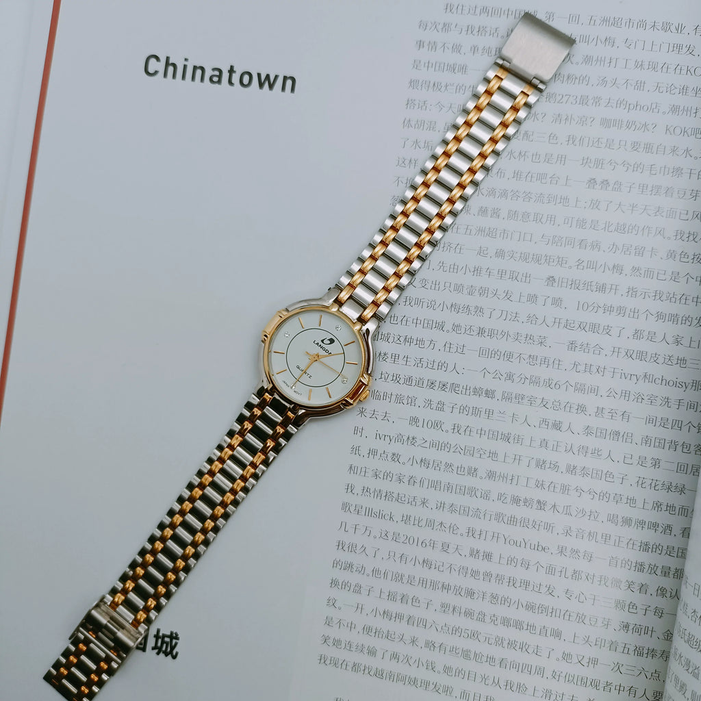 Reloj de cuarzo vintage unisex con brazalete metálico bicolor y movimiento importado NOS