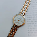 Reloj de cuarzo vintage unisex con brazalete metálico bicolor y movimiento importado NOS