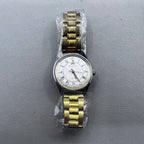 32mm golden stainless steel manual watch with 17 jewels and Roman numeral dial.
