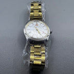 32mm golden stainless steel manual watch with 17 jewels and Roman numeral dial.
