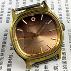33mm Shanghai manual watch with golden nail markers, square case, and 17-jewel movement on brown dial.