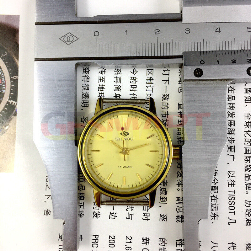34mm manual mechanical watch with 17 jewels, golden dial, and round gold case, classic style.